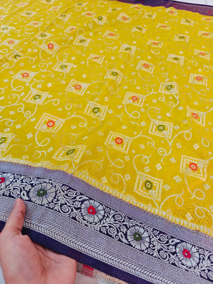 KHADDI GEORGETTE IN GOLD AND VIOLET COLOUR BORDER