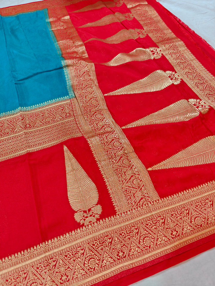 TORQUOISE BLUE KHADDI GEORGETTE WITH KAIRI BOOTA ON RED BORDER