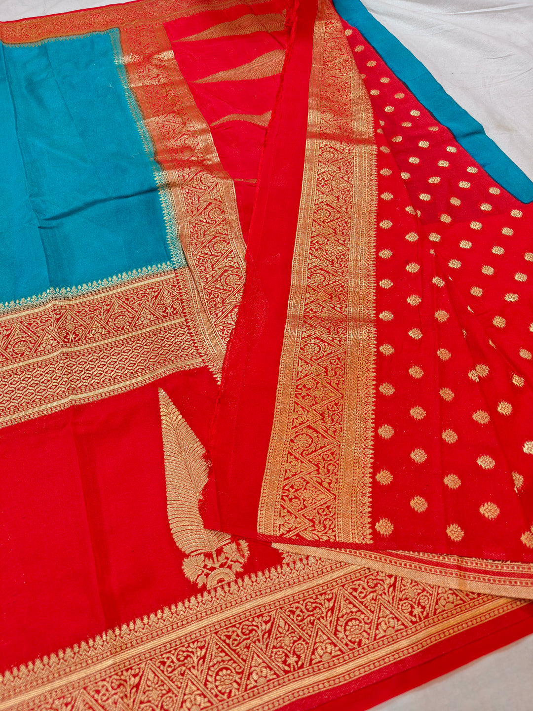 TORQUOISE BLUE KHADDI GEORGETTE WITH KAIRI BOOTA ON RED BORDER