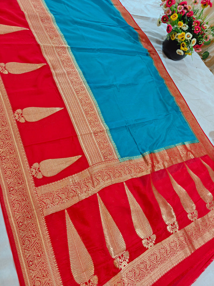 TORQUOISE BLUE KHADDI GEORGETTE WITH KAIRI BOOTA ON RED BORDER