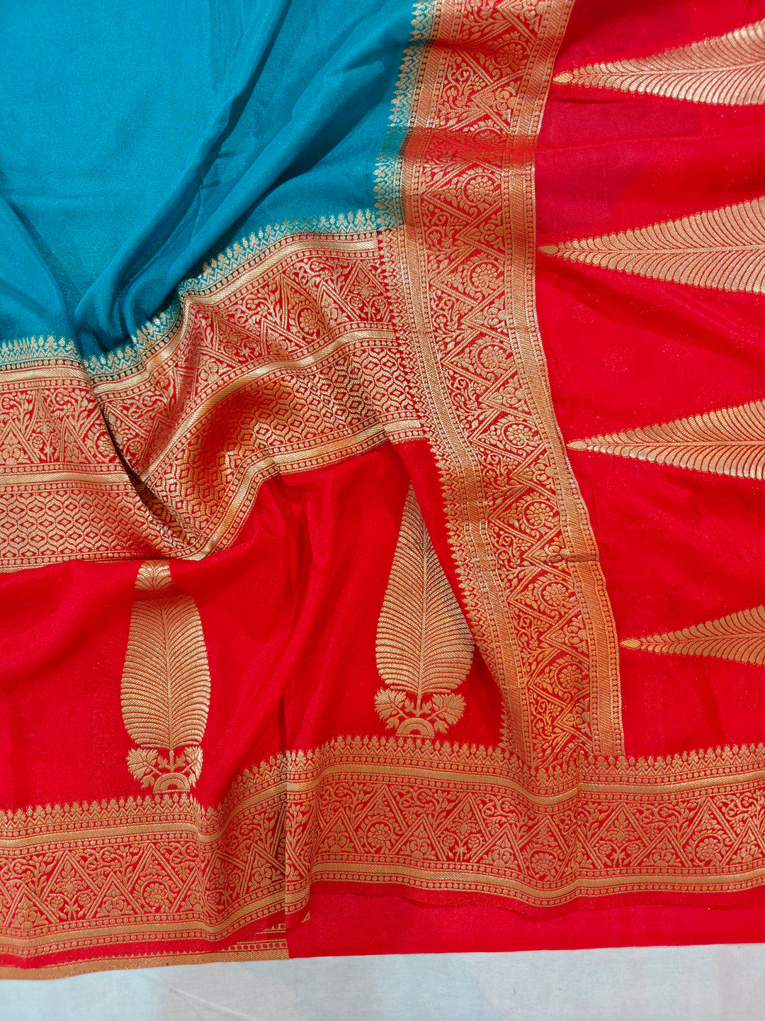 TORQUOISE BLUE KHADDI GEORGETTE WITH KAIRI BOOTA ON RED BORDER