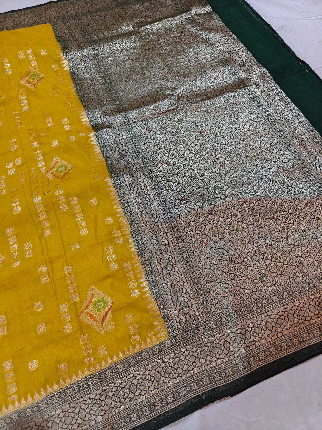 YELLOW KHADDI GEORGETTE WITH BOTTLE GREEN BORDER