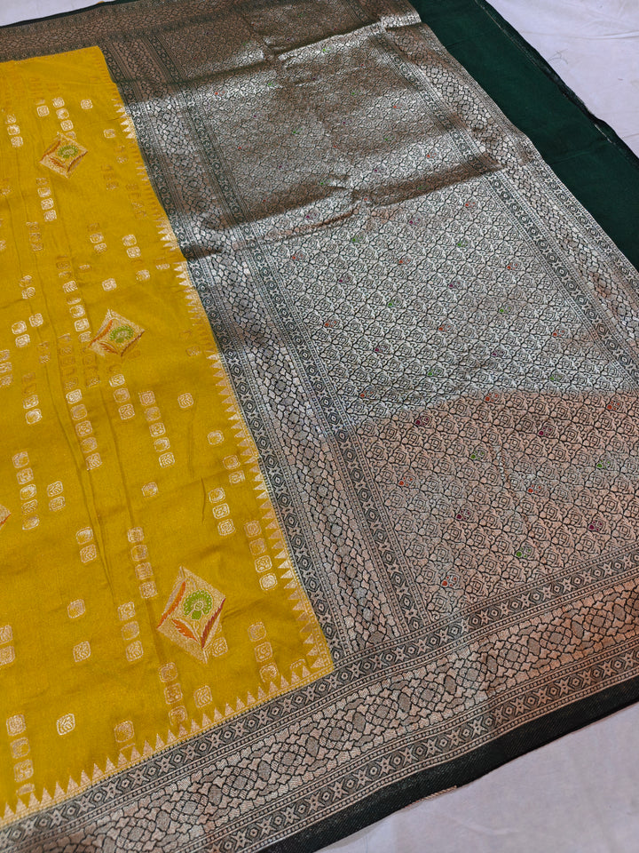 YELLOW KHADDI GEORGETTE WITH BOTTLE GREEN BORDER