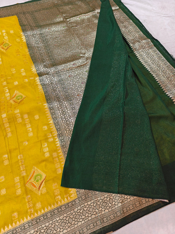 YELLOW KHADDI GEORGETTE WITH BOTTLE GREEN BORDER