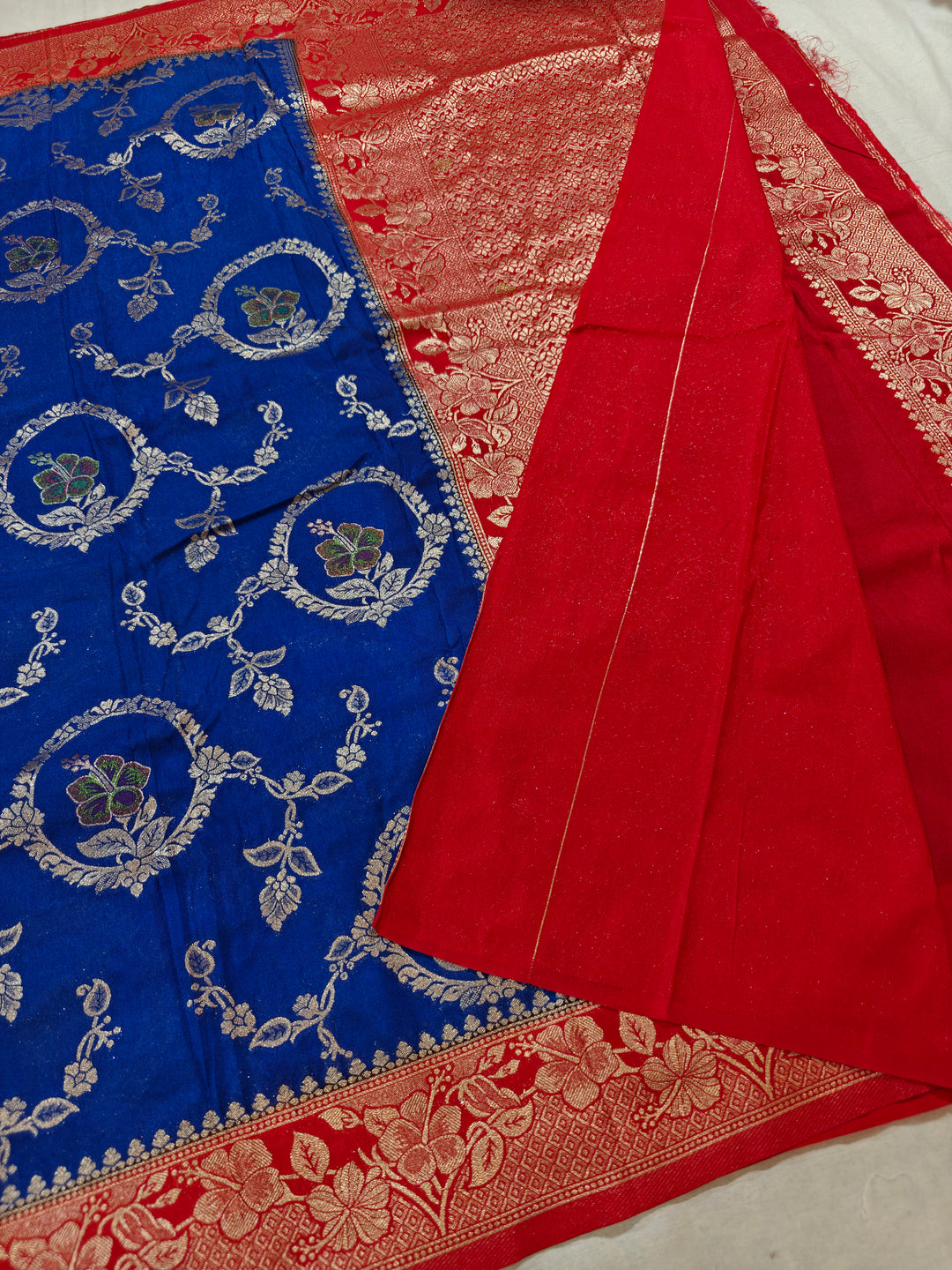 KHADDI GEORGETTE IN ROYAL BLUE WITH RED BORDER