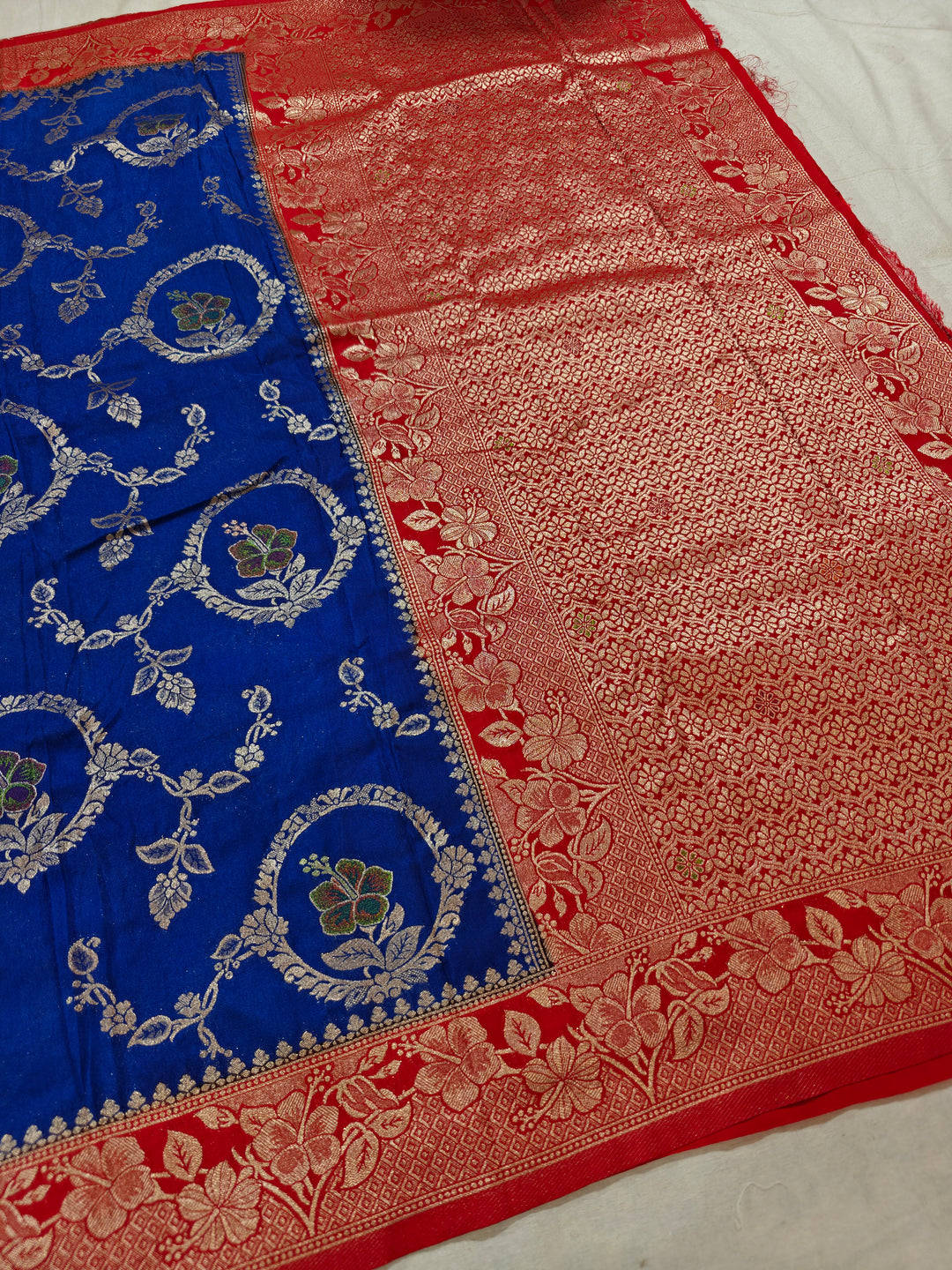 KHADDI GEORGETTE IN ROYAL BLUE WITH RED BORDER